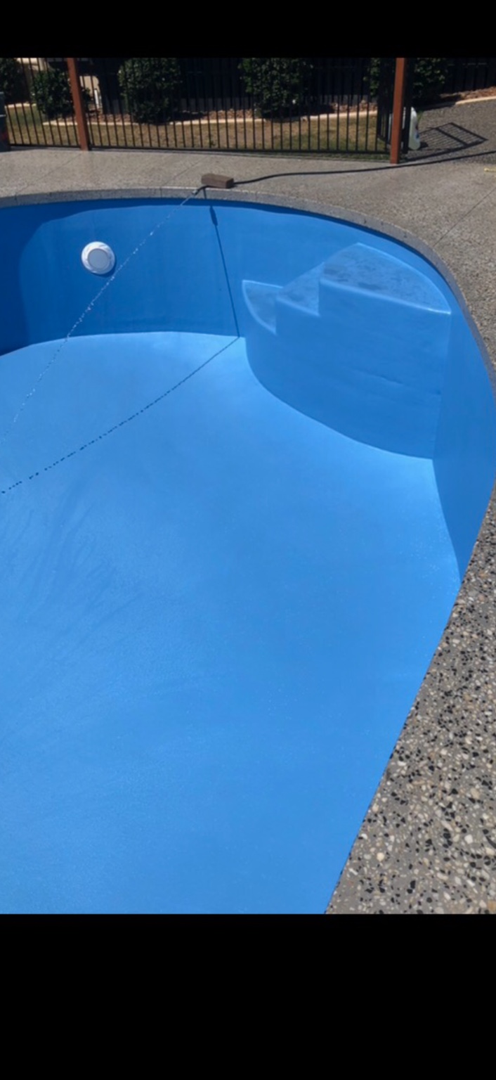 Blue fibreglass pool steps and curved surface